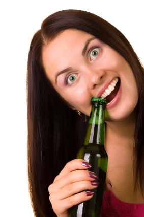 Young woman trying to open a bottle of beer with her teeth