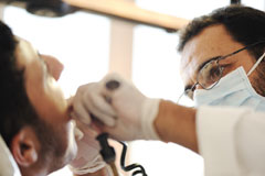 A dentist treating a sedated patient