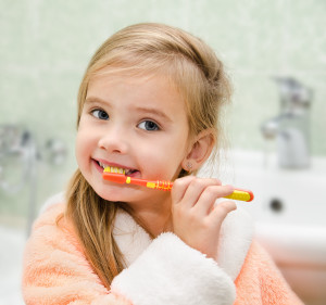 Smiling Little Girl Brushing Teeth