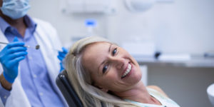 happy woman sitting in dental exam chair