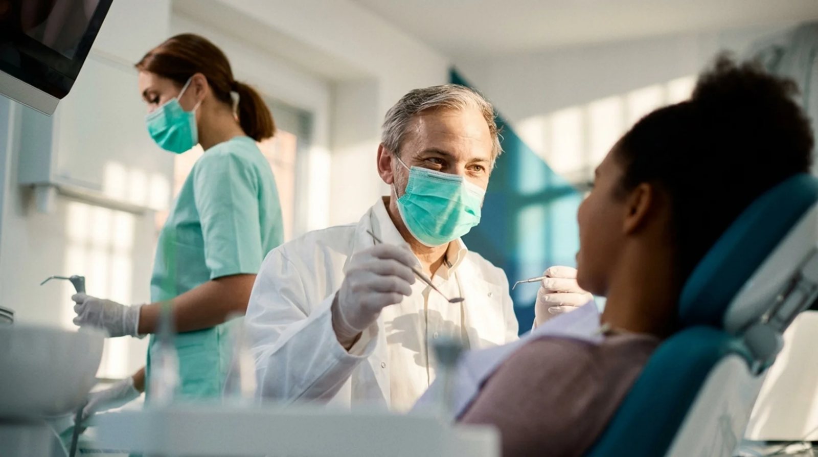 Hygienist coordinating care with periodontist at Island Dental